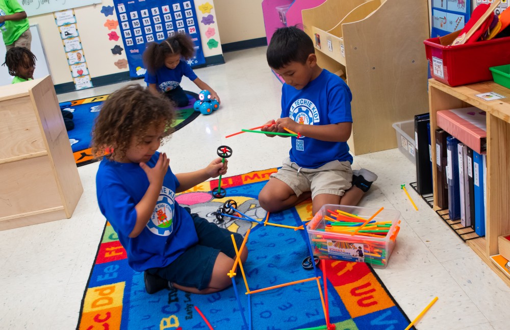 Happy kids learning technology skills at Learnovo Kids Academy